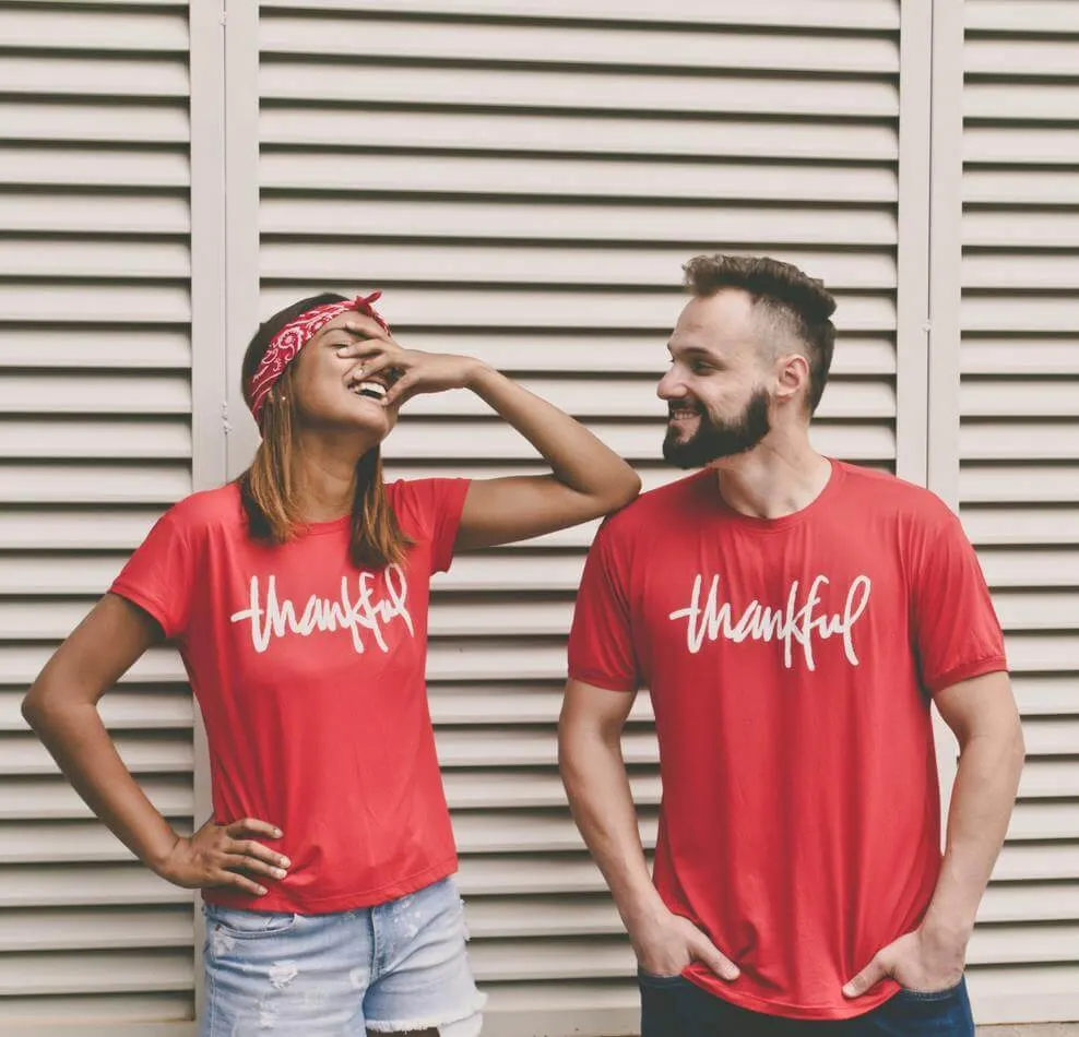 Photograph of a boy and a girl wearing red T-shirts with "thankful" written on them
