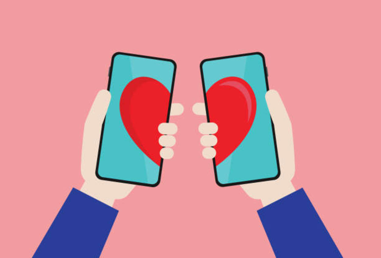 two people holding their phone together with hearts