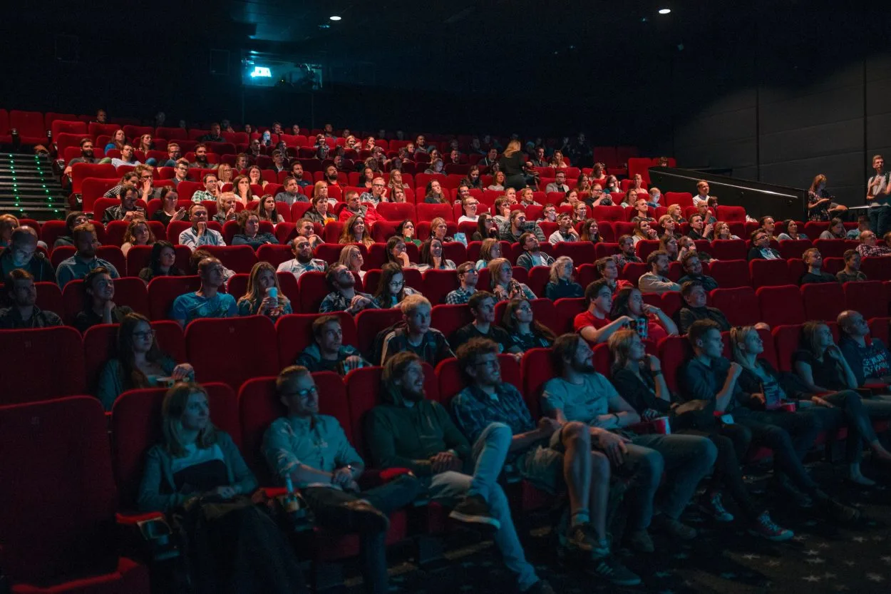 A theater is filled with people who are enjoying a movie
