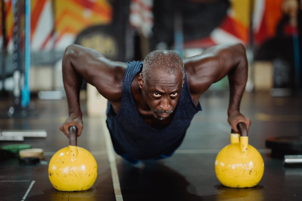 A person doing push-ups with balls