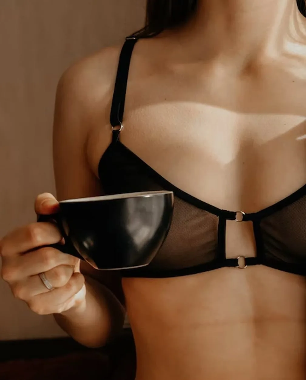 A person in their underwear carrying a tea cup