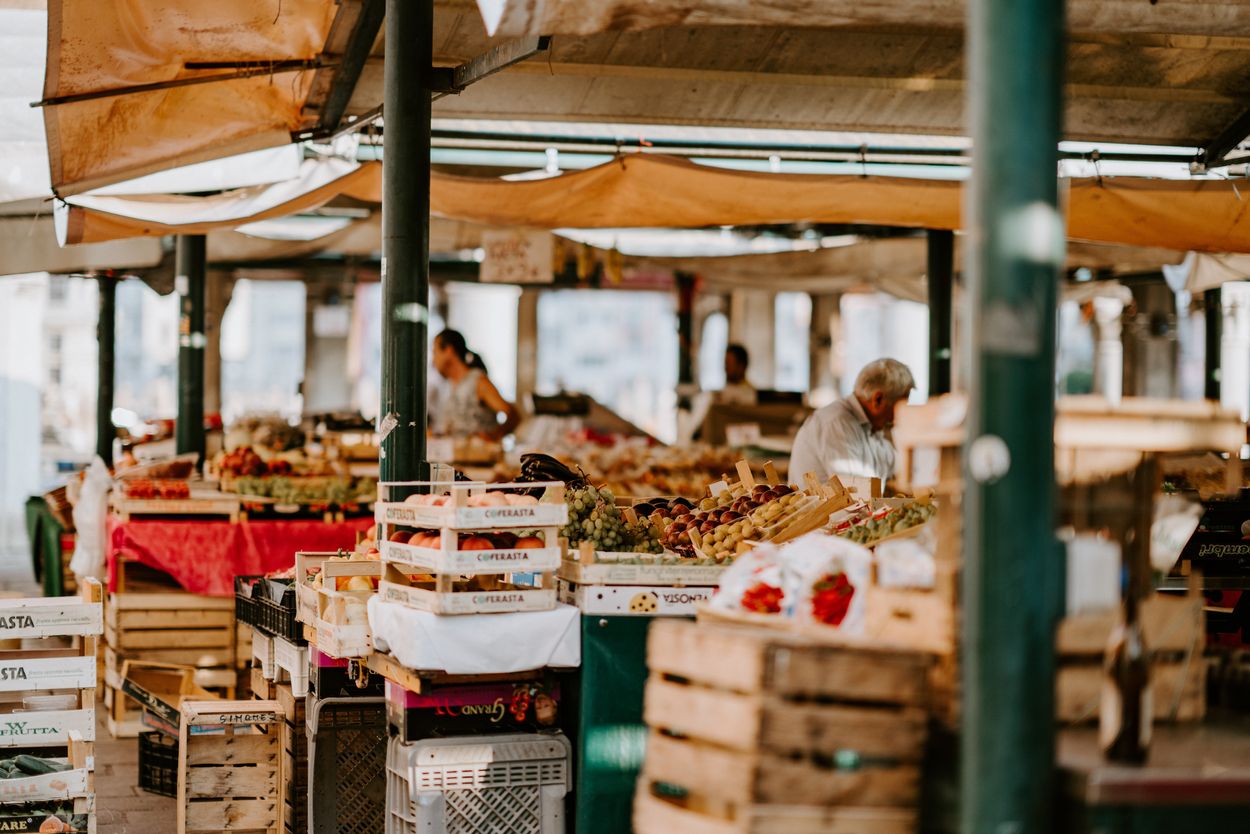 A marketplace with crates full of fruit