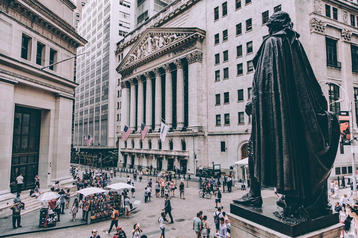 An image of bustling Wall Street New York