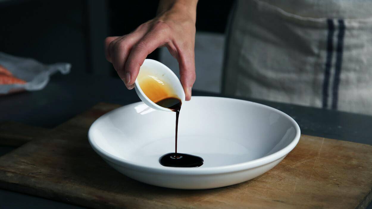 Pouring sauce in a bigger bowl.