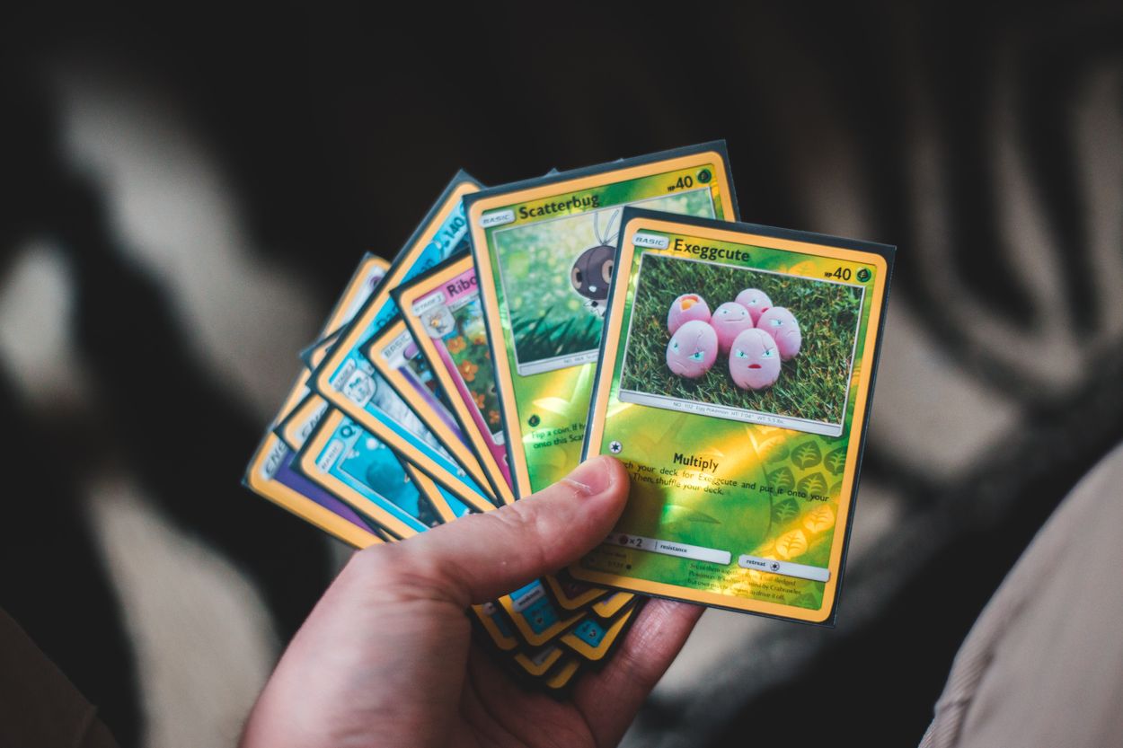 A person holding a bunch of Pokemon cards