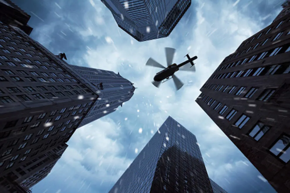 A cinematic view of a helicopter between 4 buildings