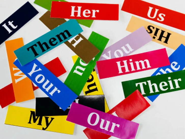 Colorful cards depicting pronouns and displayed on a white background