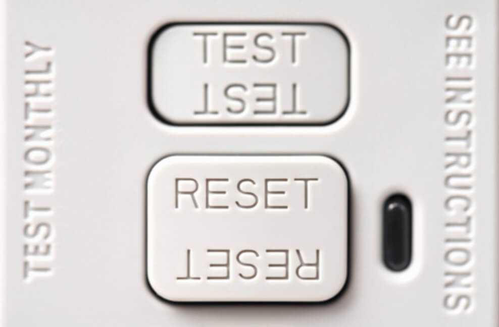 An image showing reset and Test buttons at the outlet of GFCI lining