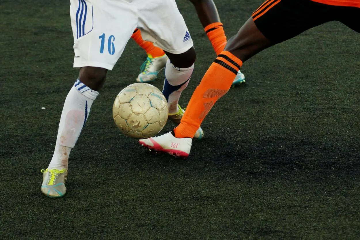 Close up shot of two man playing football.