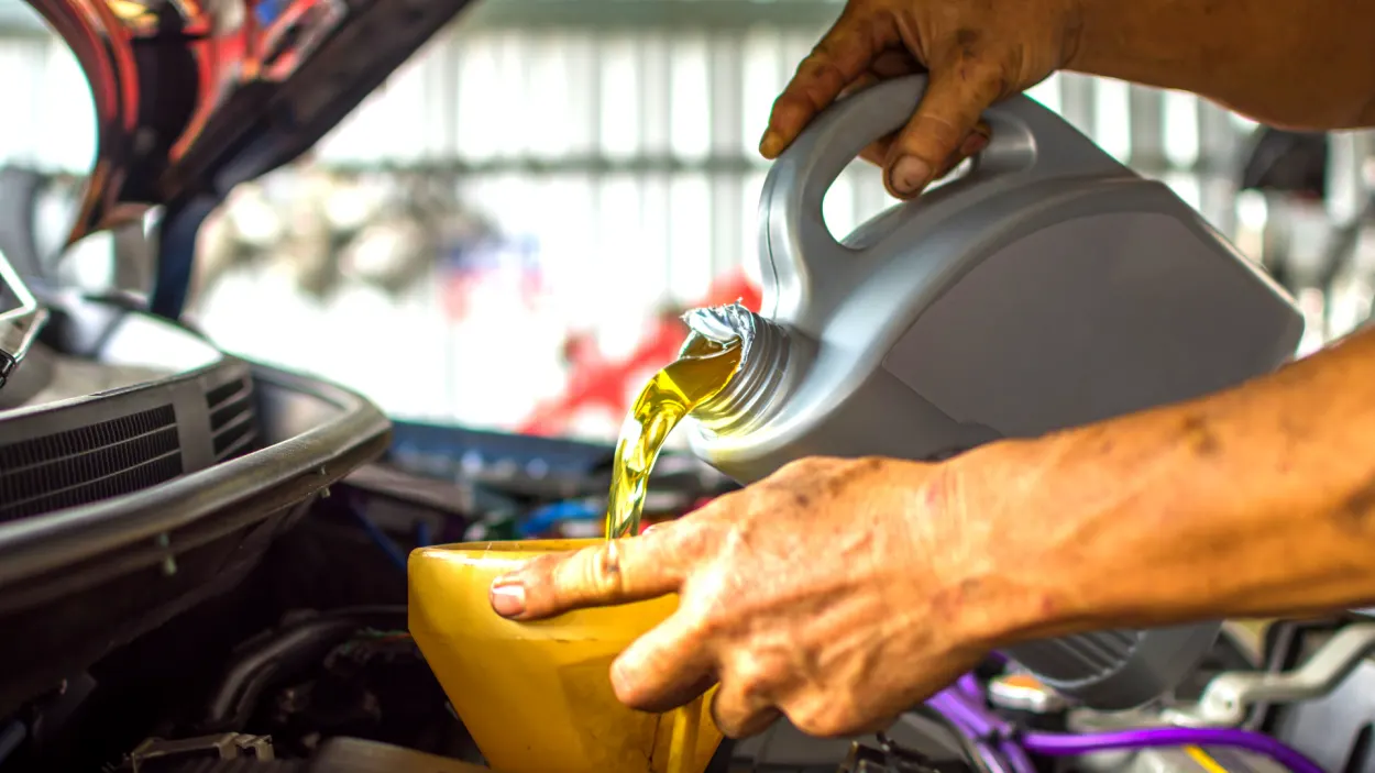 engine oil being poured into a car