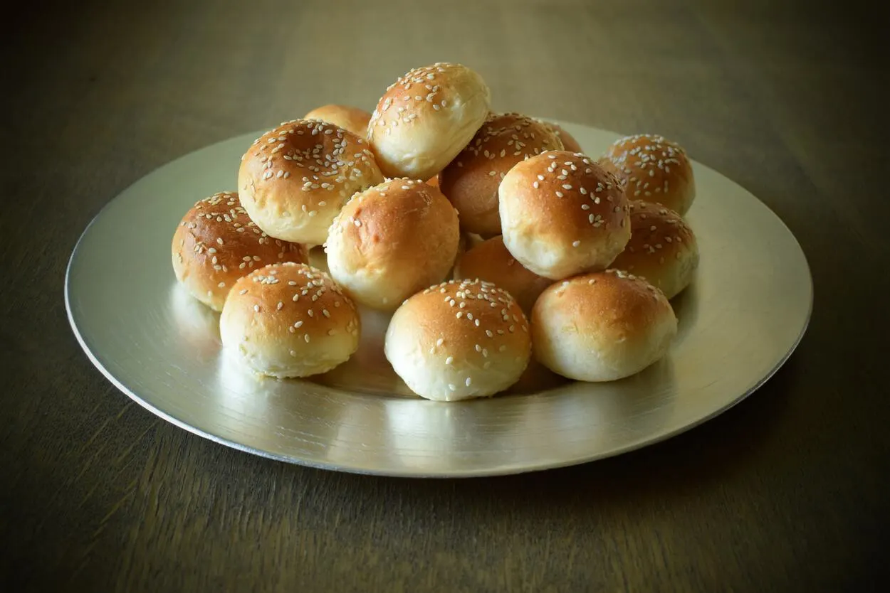 An image of a plate with small round buns.