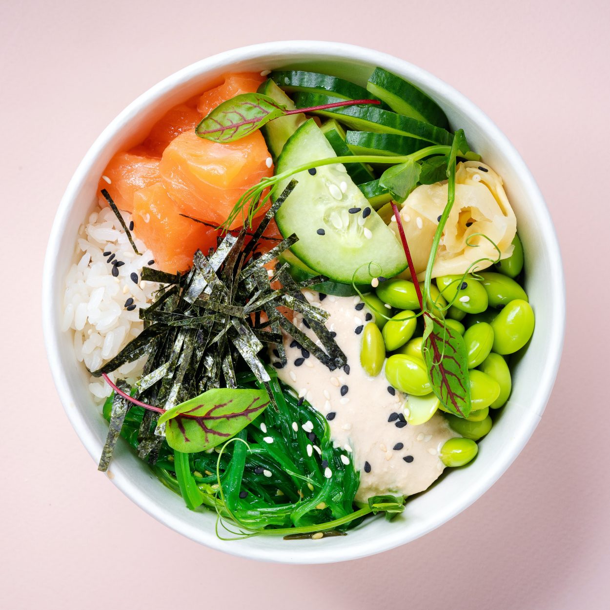 An image of a bowl of rice with vegetables on top.