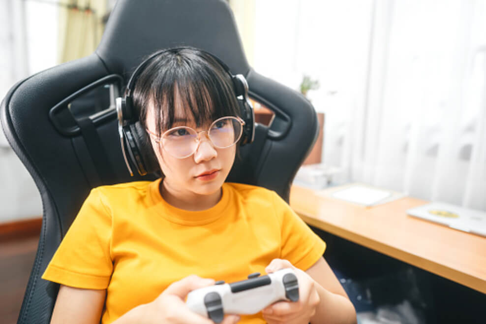 An image showing a girl playing plays station