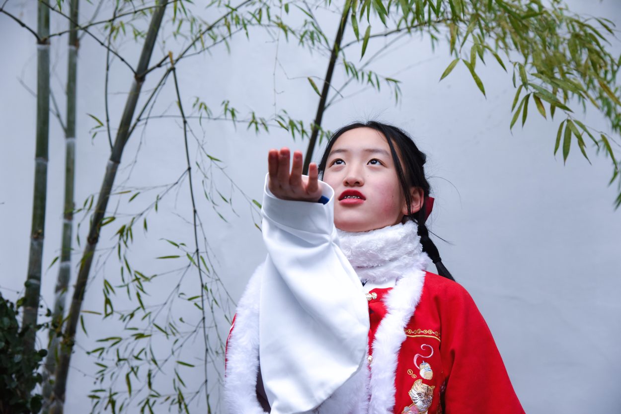 A girl dressed in red colored Chinese traditional clothing
