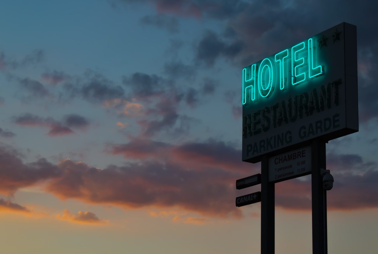 A neon sign that says Hotel