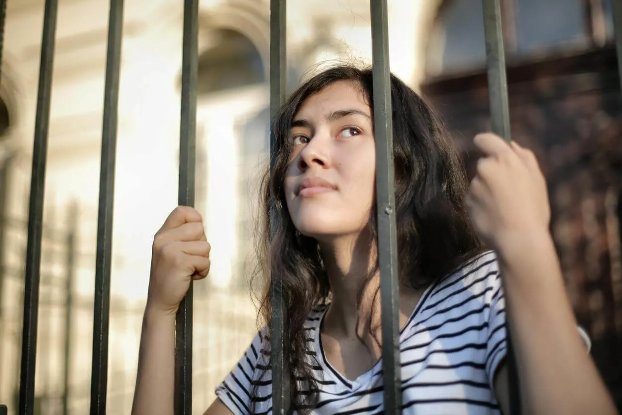 a girl behind bars