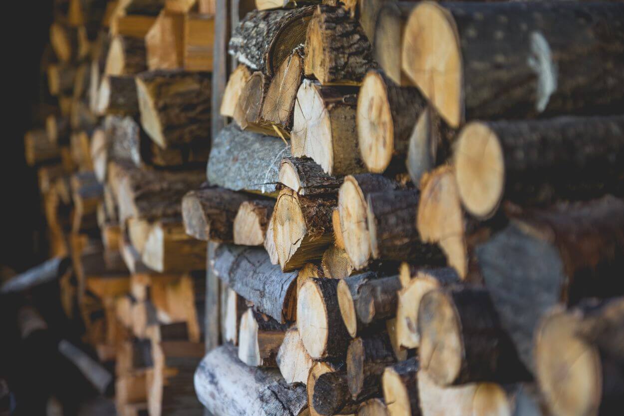 logs of wood stacked on top of each other.