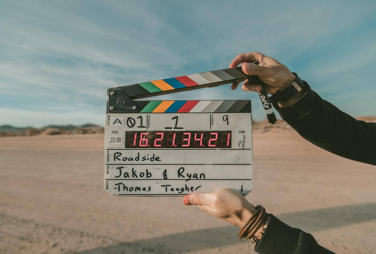 a person holding  a clapboard