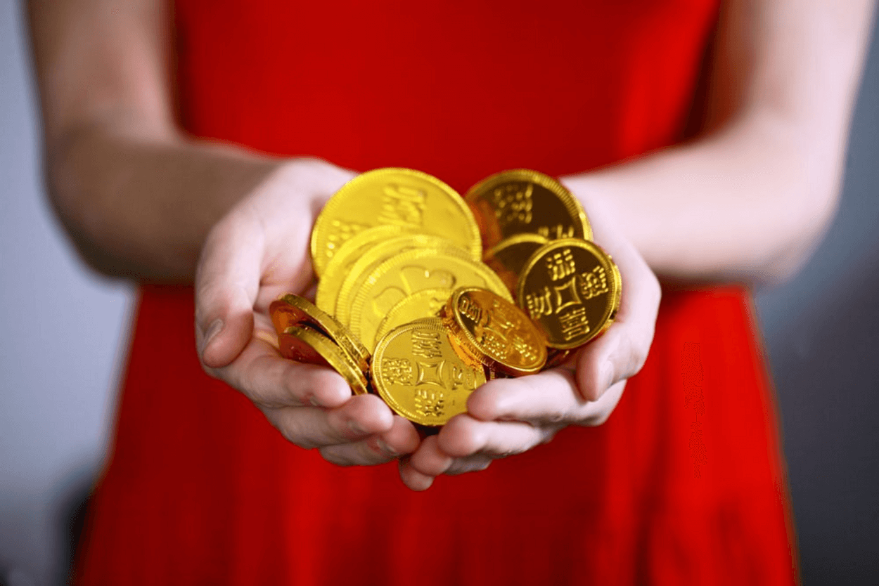 a person holding gold coins