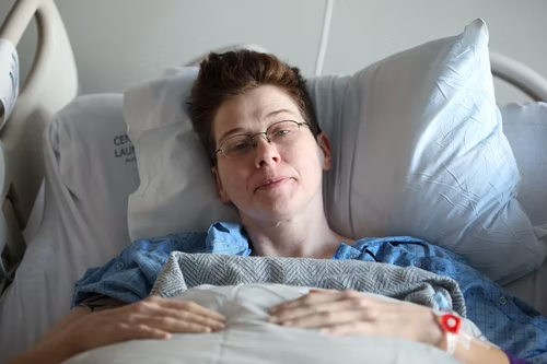 woman lying on hospital bed