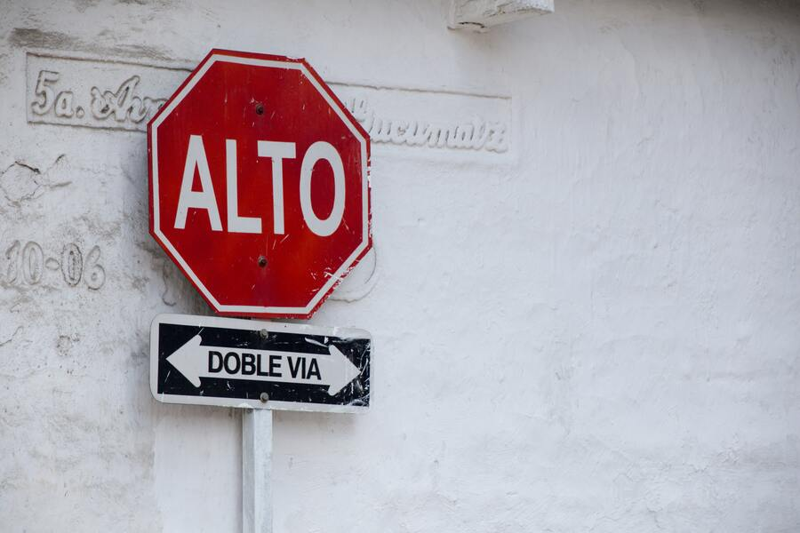 A Stop Sign in Spanish Which is Indicating Double Roads