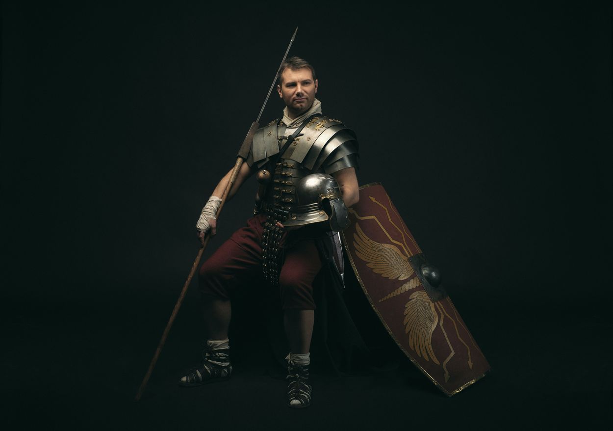 a person in full knight armor with a spear