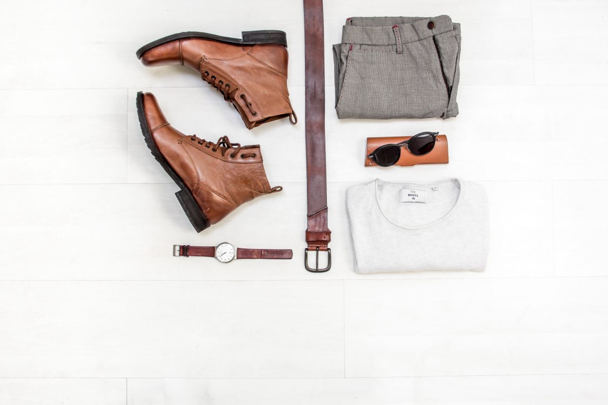 Picture of an outfit with a pair of brown boots laid out.
