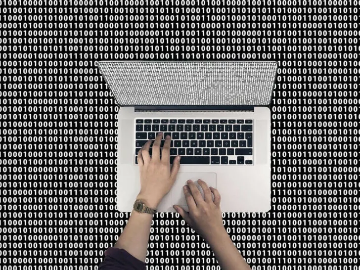 An image of a laptop and binary functions of coding