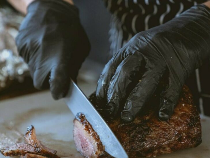 Butcher slicing to make steak