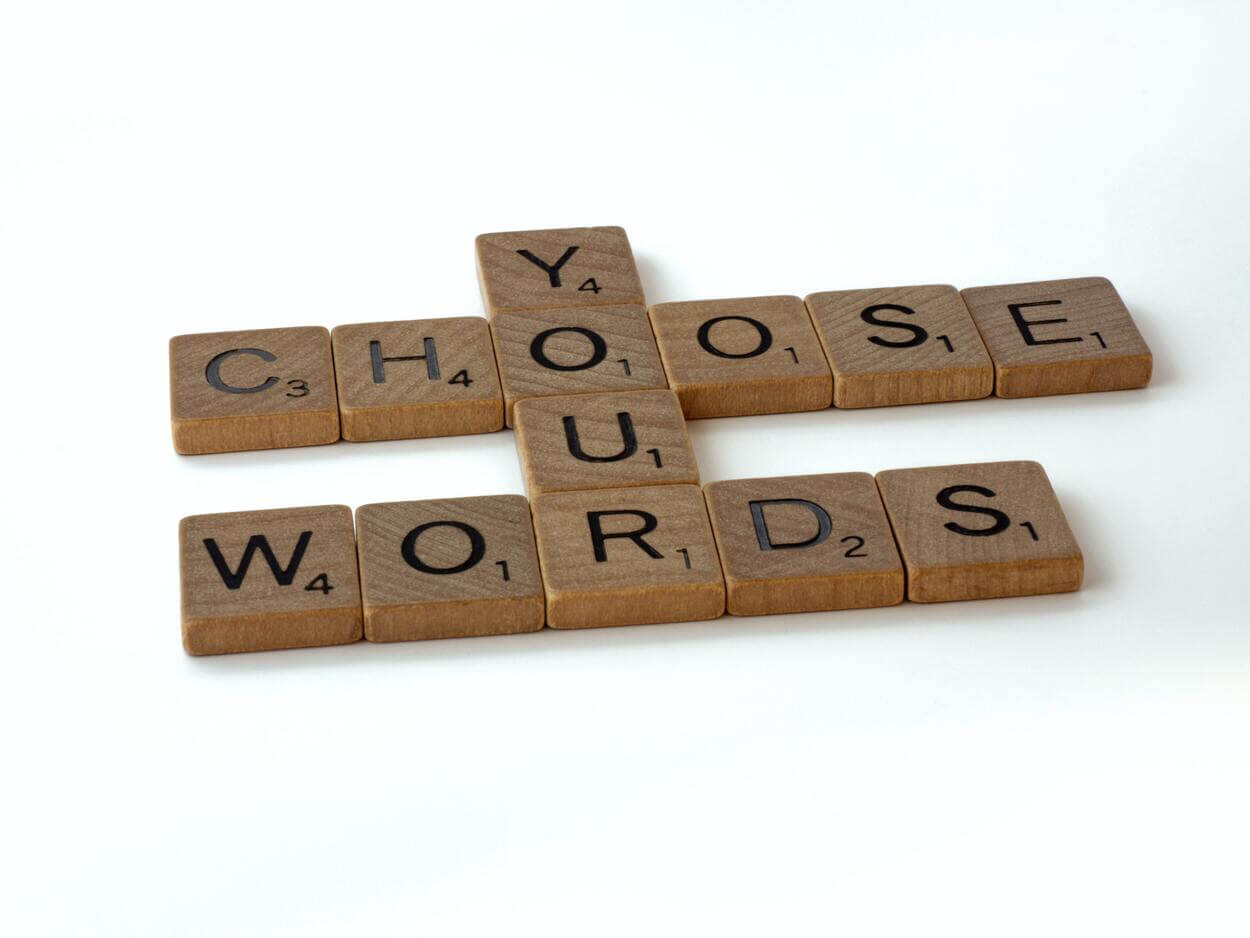 scrabble tiles spelling out the words "Choose your words"