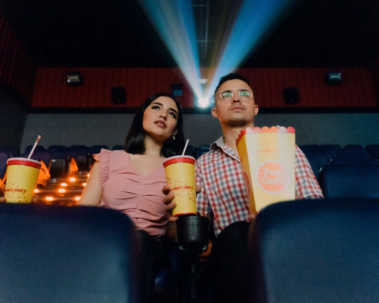 a person watching the movies with popcorn and a drink