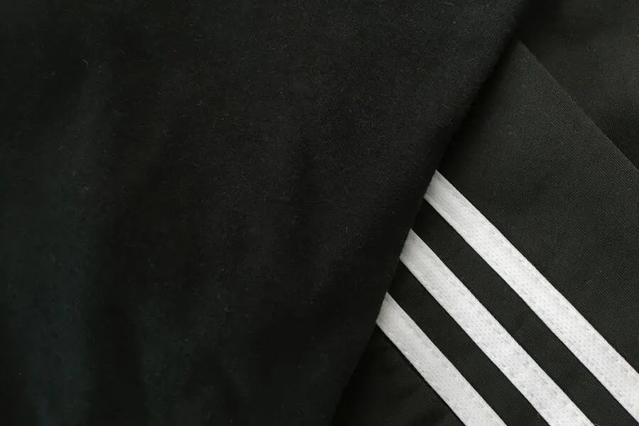 A picture showcasing a closeup shot of black and white sweatpants.