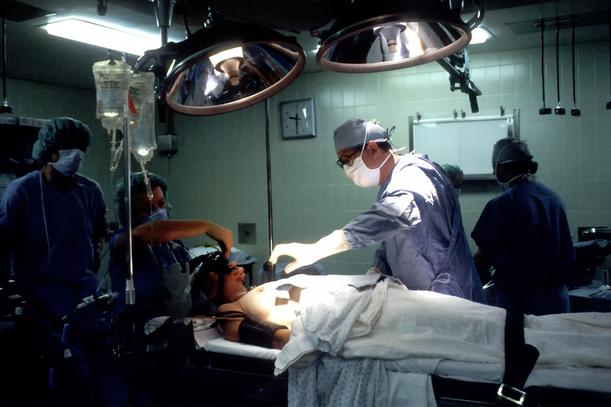 Doctor and nurses operating on a patient suffering from breast cancer