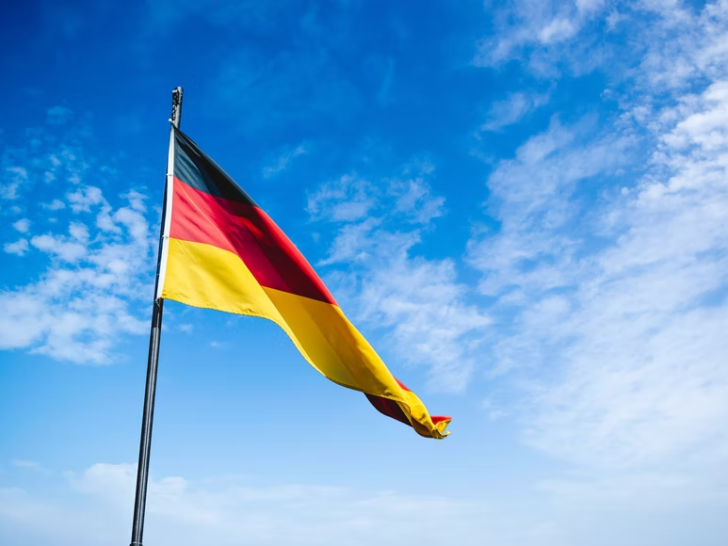 An image of the German flag under the blue sky