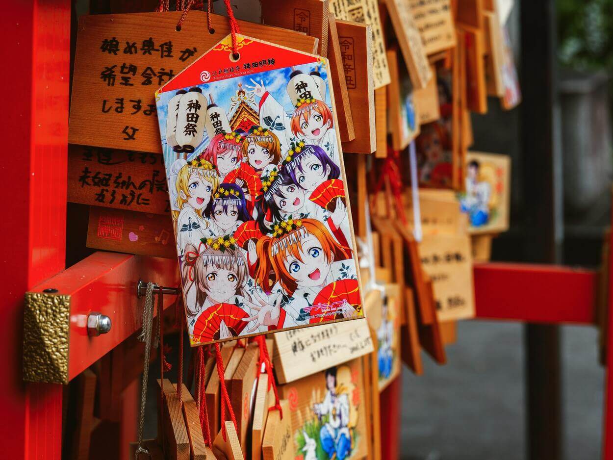 An image of Japanese anime characters hanging in a shop.