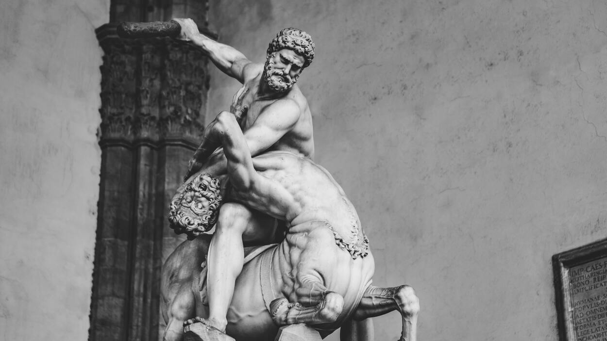 An image of a centaur and a man engaged in a fight.