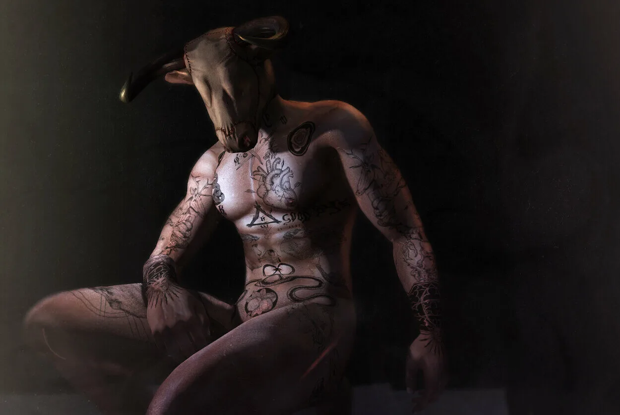 An image of a tattooed man wearing a bull's head mask and portraying as a Minotaur.
