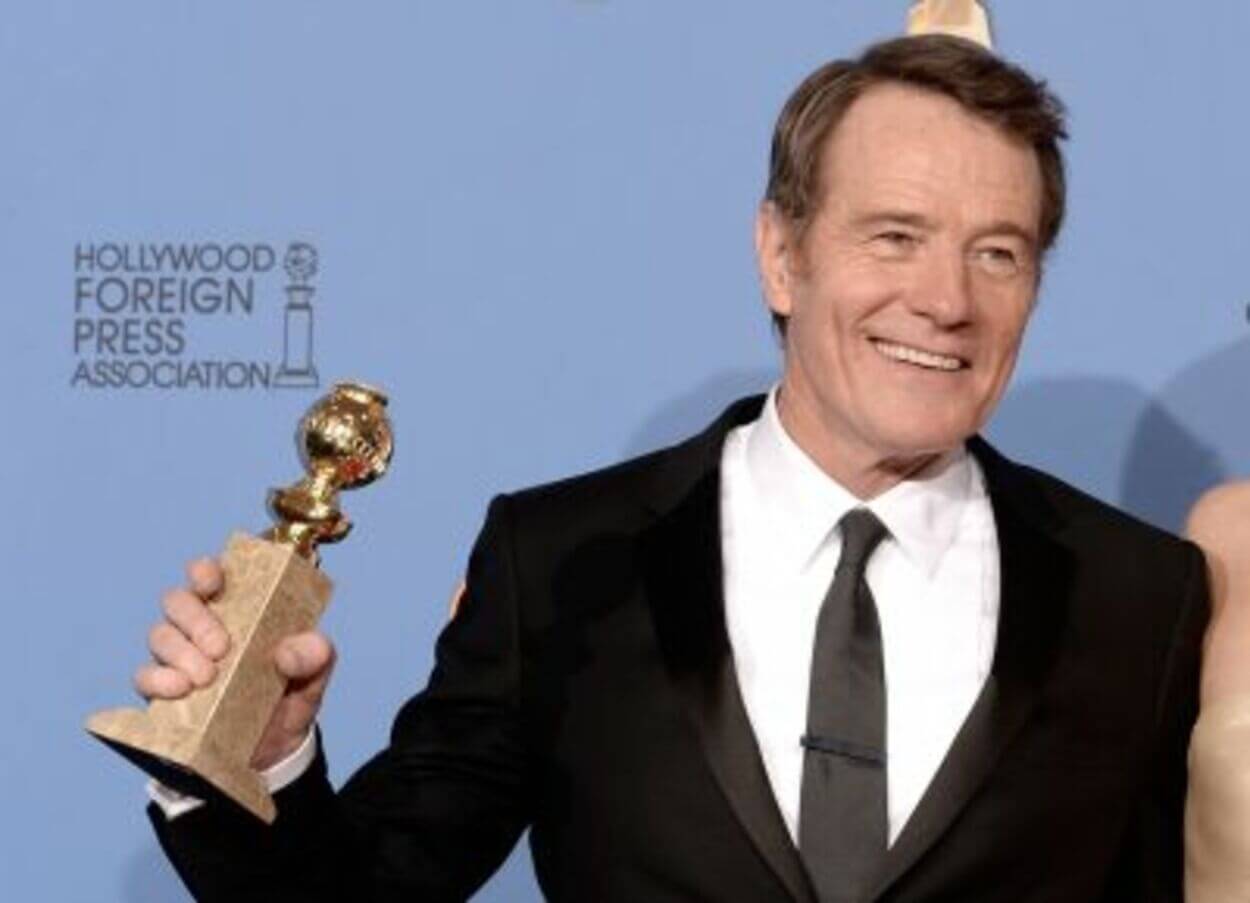 An image of an actor holding a golden globe award.
