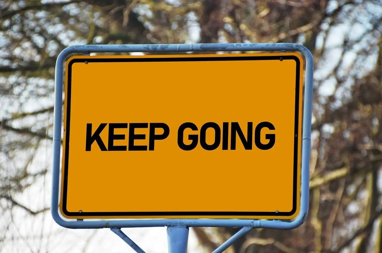 An image of a board with the textof "keep going."