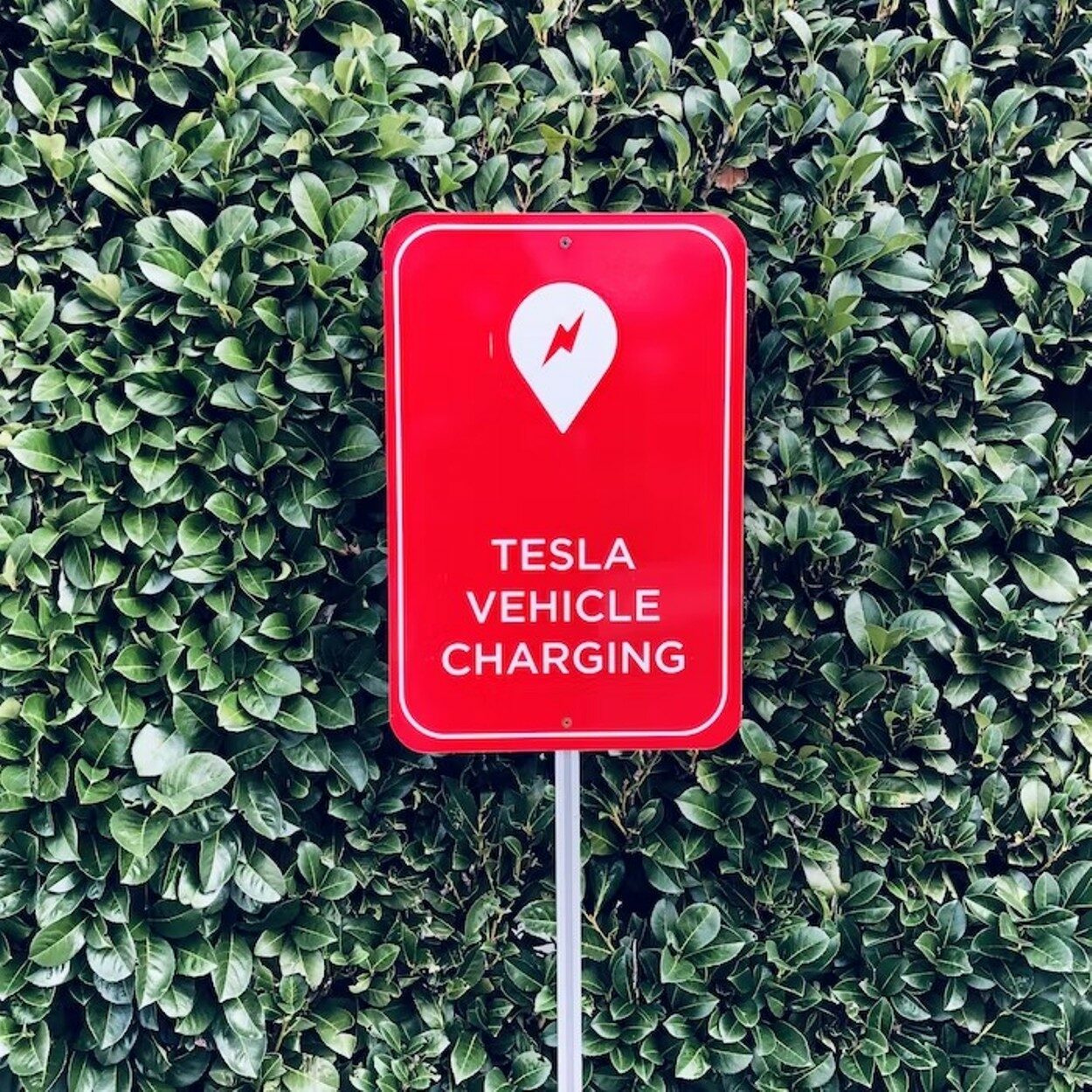 A sign board showing the tesla charging logo