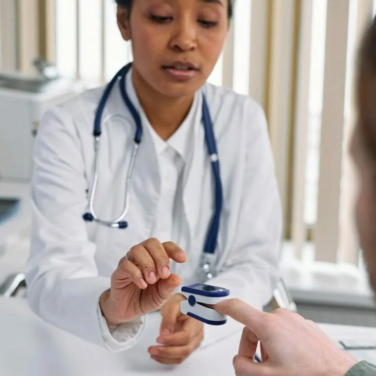 A doctor checking heartbeat of a patient