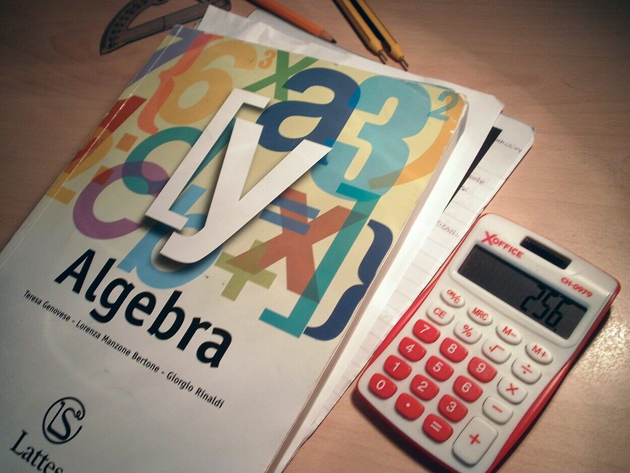 Image of a book of algebra and a calculator.
