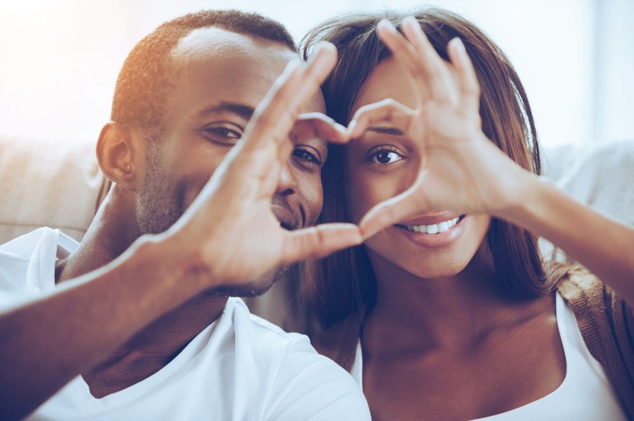 couple making a heart with their hands