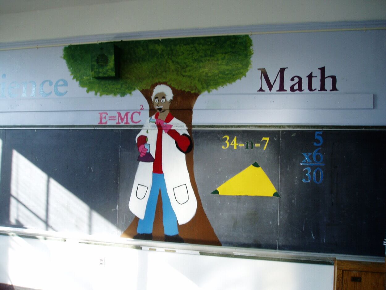 Image of a black board in a classroom. 