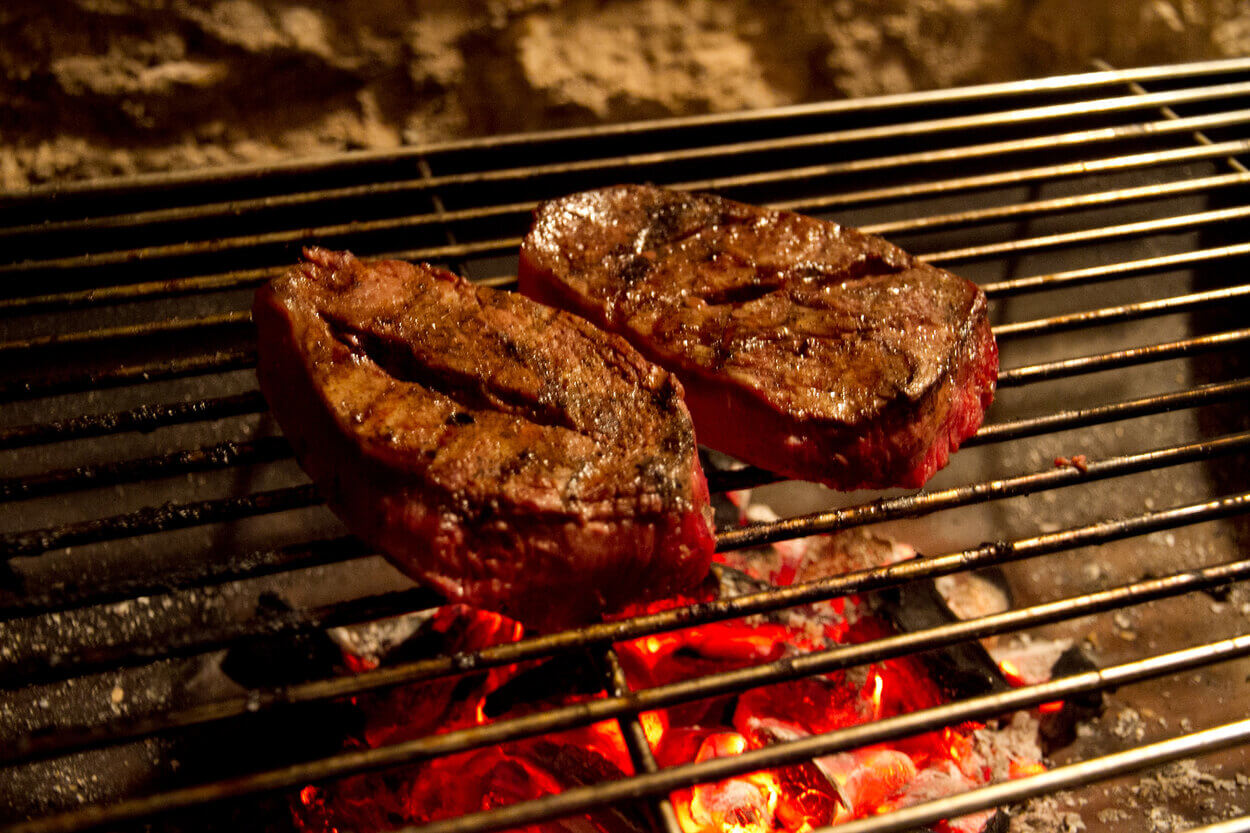 Picture of a steak on a grill.