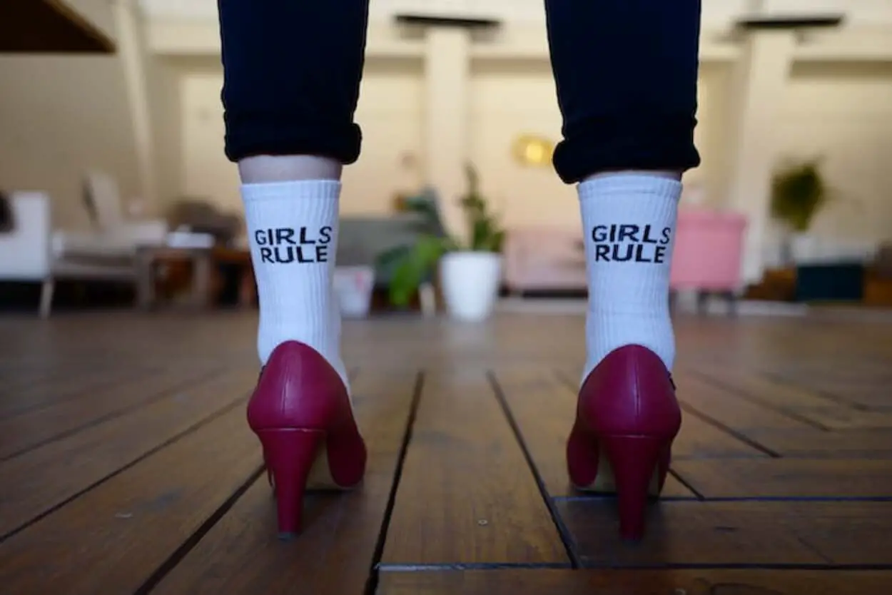 A girls wearing maroon pumps in socks