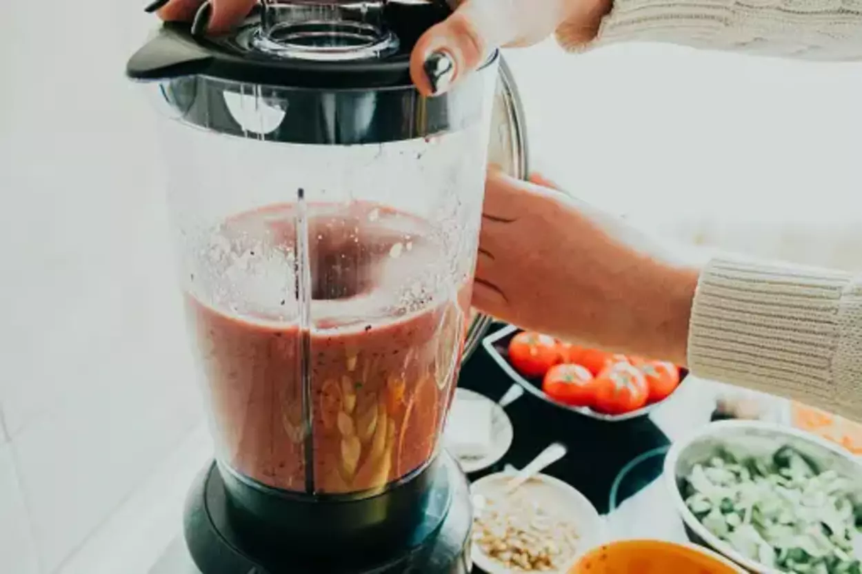 woman making smoothie in a blender