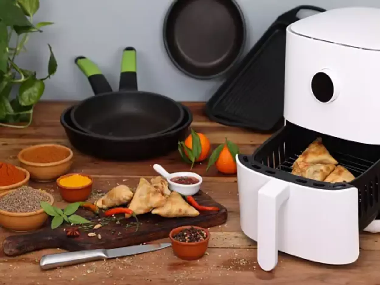 An air fryer with food items inside its basket.