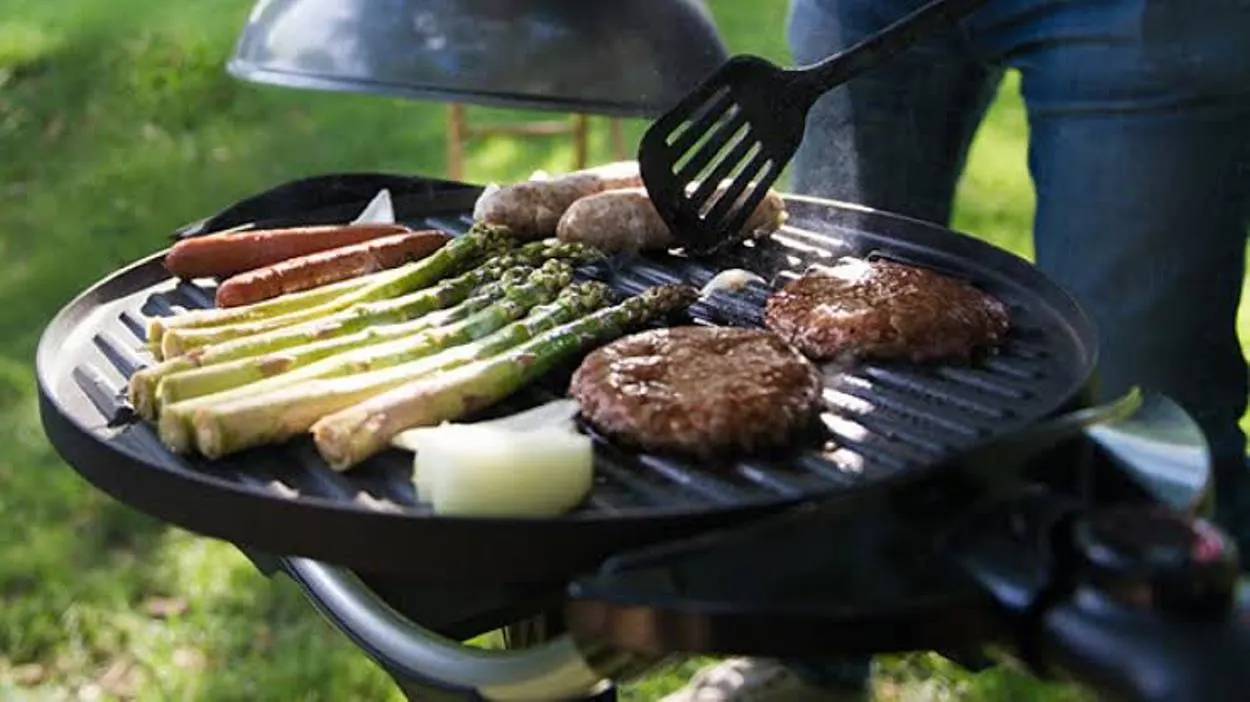 A person using an electric grill outdoors